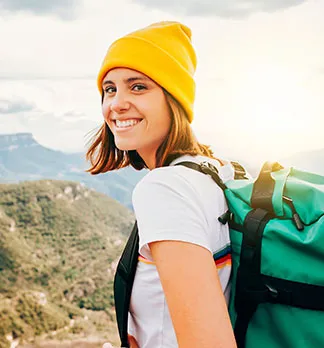 young woman on mountain smiling